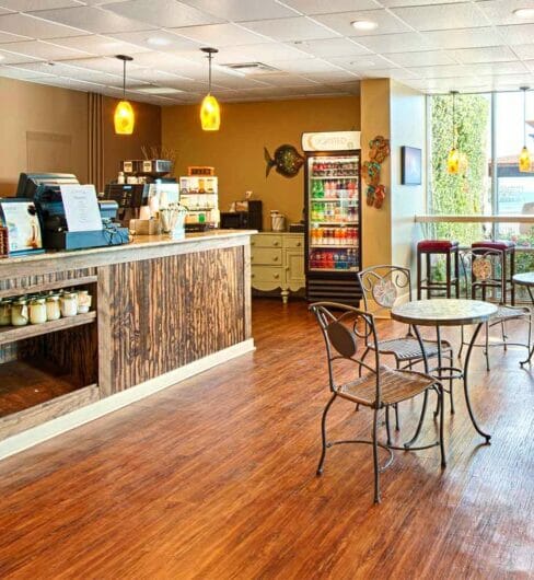 interior of cafe with bar seats and double tables