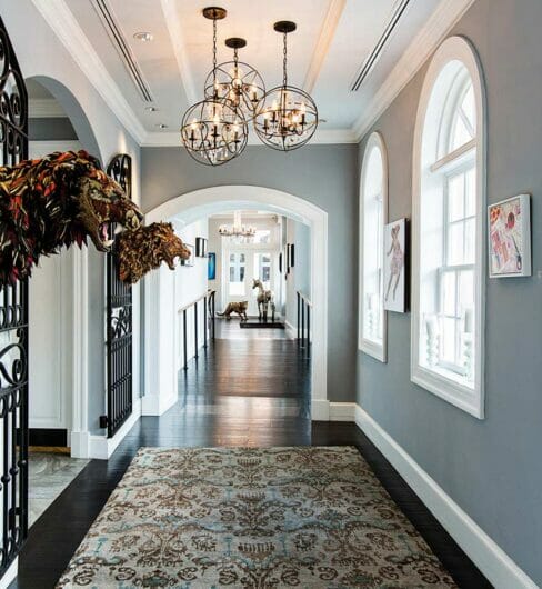 well lit hallway covered with pieces of original artwork