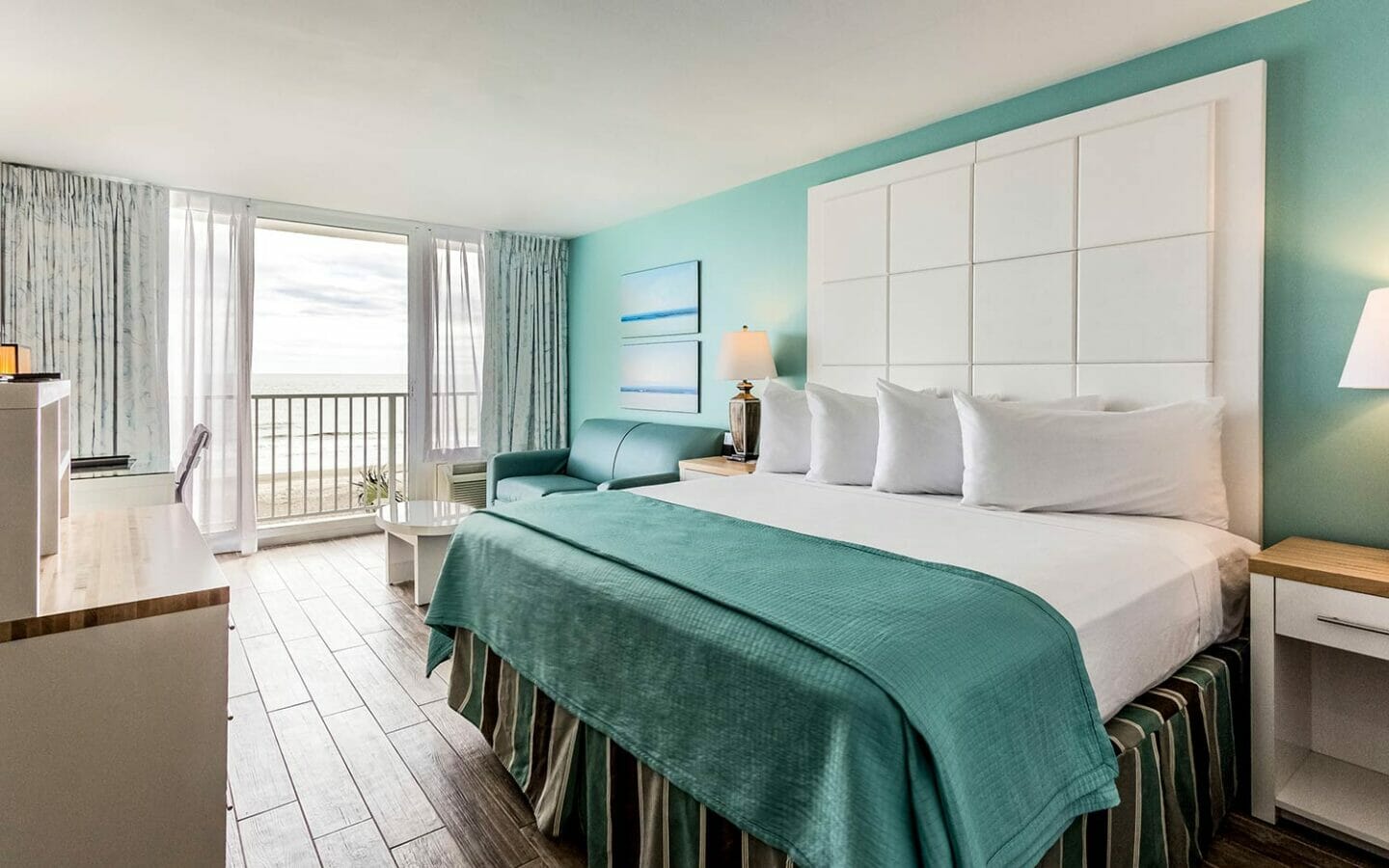 sunny beach view hotel room with king bed