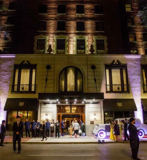 Front Exterior of The Read House hotel lit by purple spotlights during night